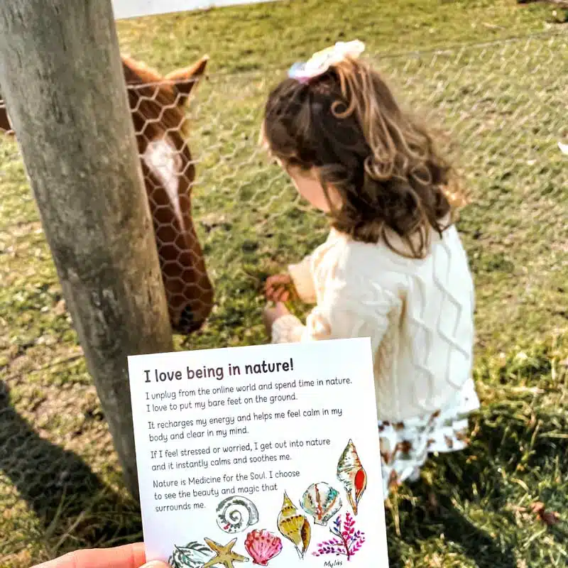 Hand holding a nature affirmation card
