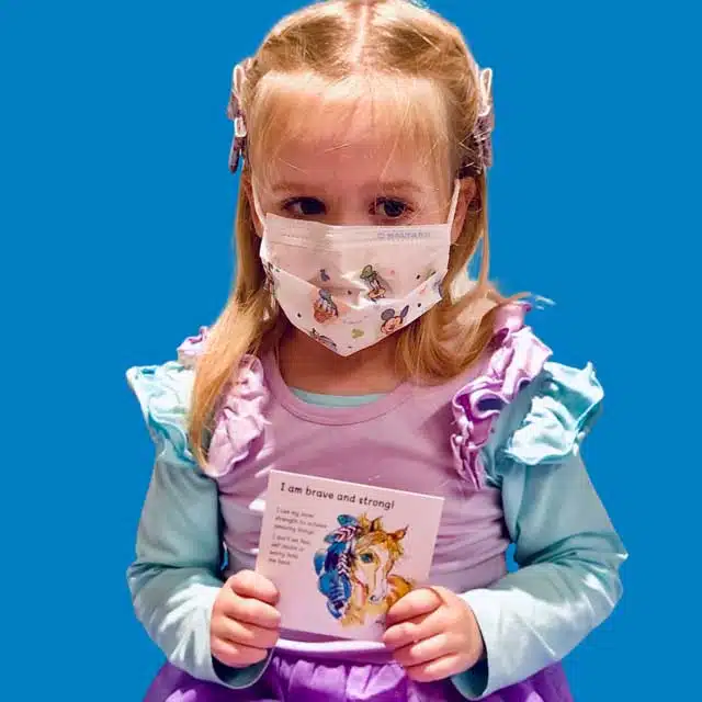 Little girl holding an affirmation card