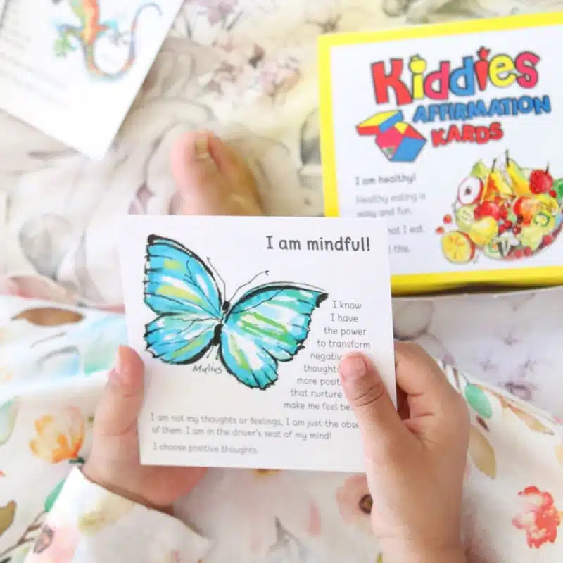 Little girl's hand holding an affirmation card