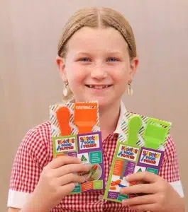Little girl holdling Kiddies Food Kutter products