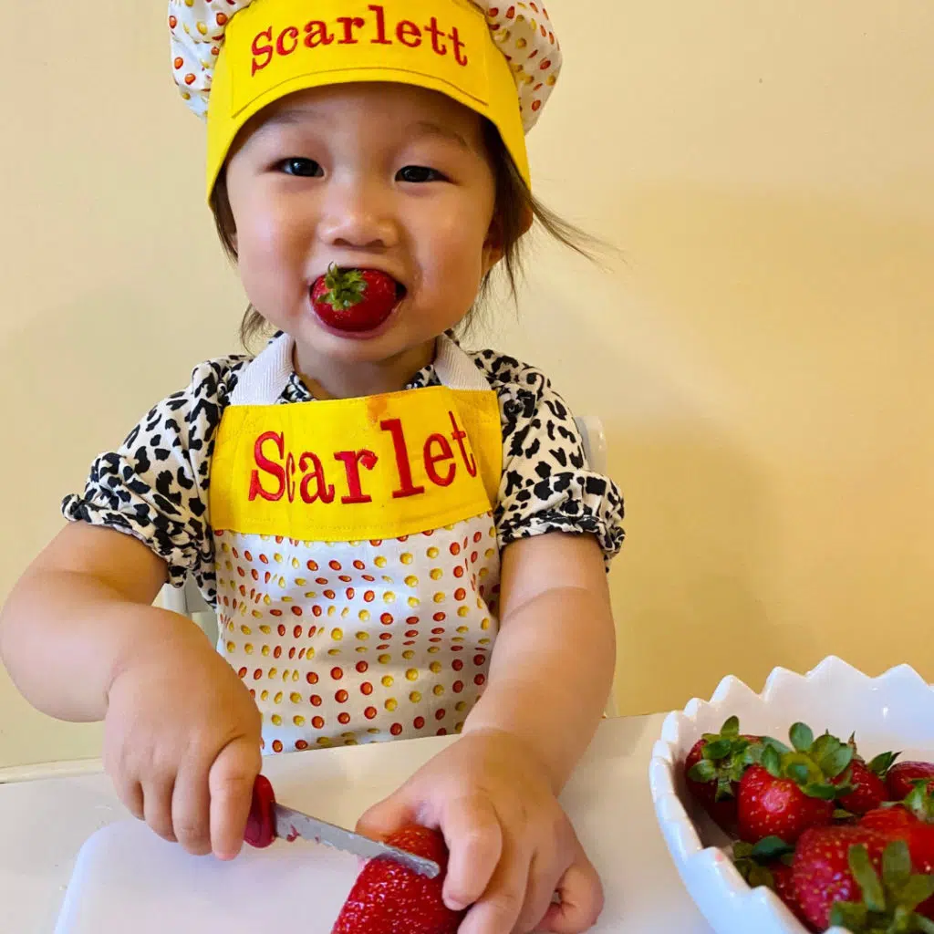 scarlett eating and cutting strawberries