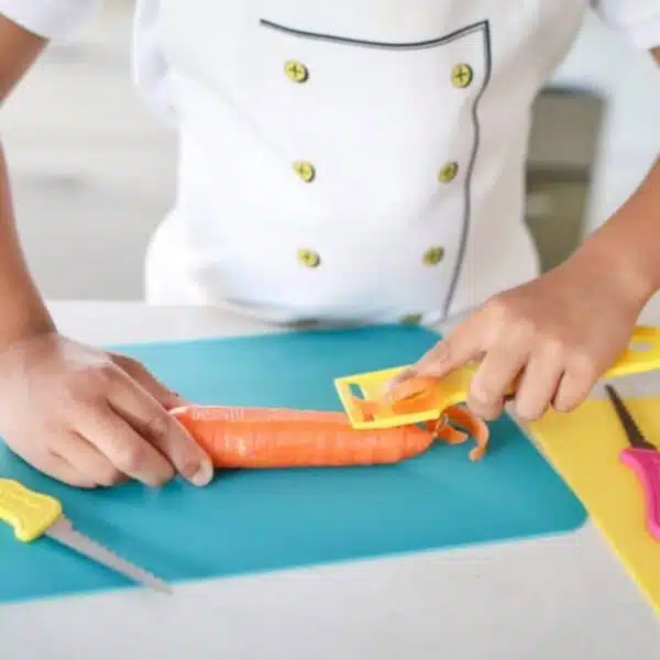 Hand peeling a carrot using a Safety Food Peeler